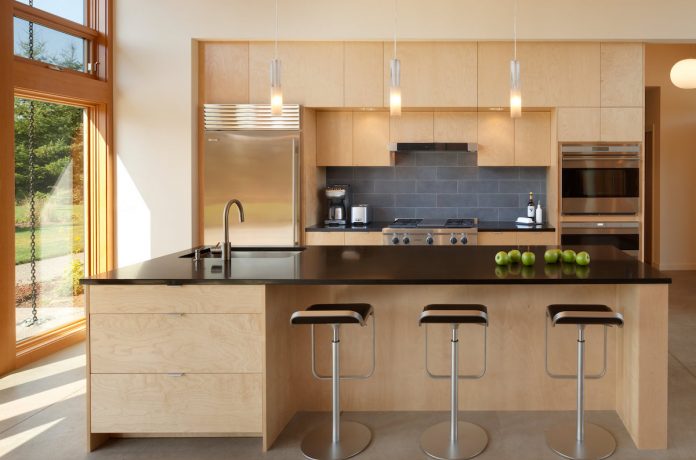 island and kitchen of Olympia Prairie Home by Coates Design